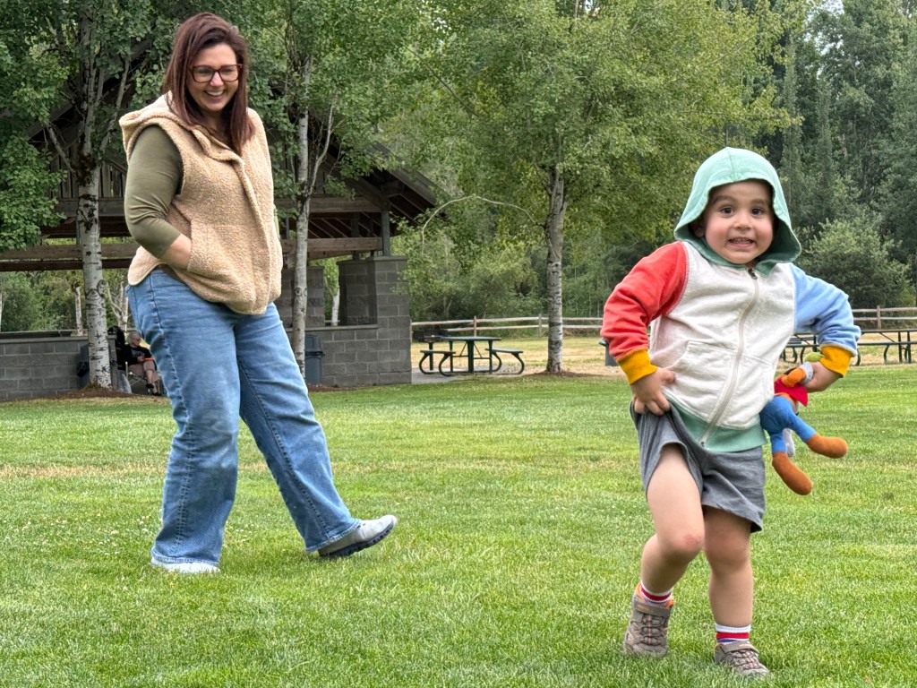 photo of young boy dancing and enjoying the Music in the Park 7/16/26 with his mother